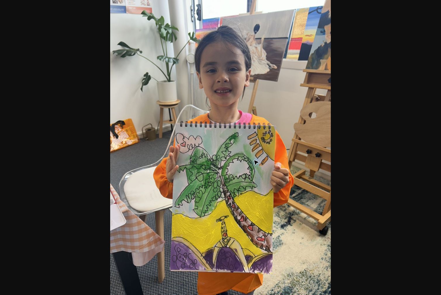 Young student showing a tropical landscape artwork in a Beginner Class at Art Space Studio Auckland